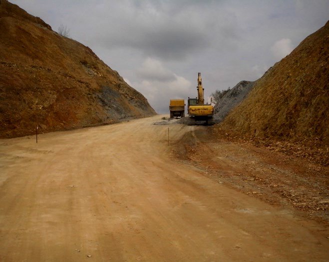 Road formation and earthworks cut through hill terrain